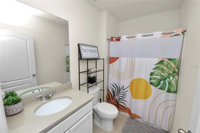 an empty room with a ceiling fan and carpet