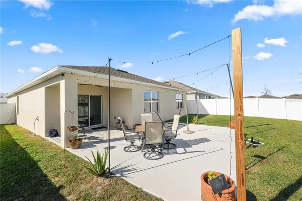 a view of a patio with table and chairs