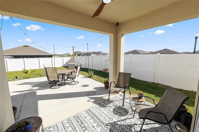 a view of a patio with table and chairs and potted plants