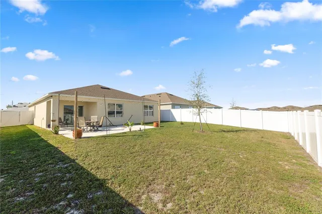 a house view with swimming pool and yard