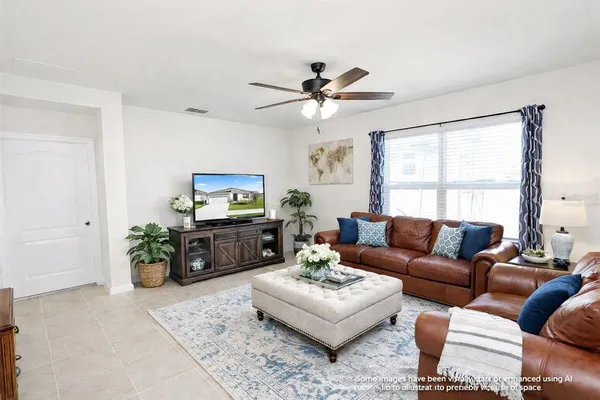 a living room with furniture a chandelier and a window