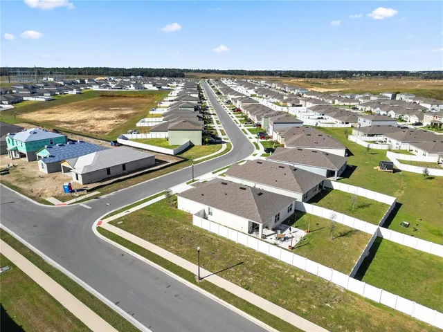 a swimming pool with a yard and outdoor seating