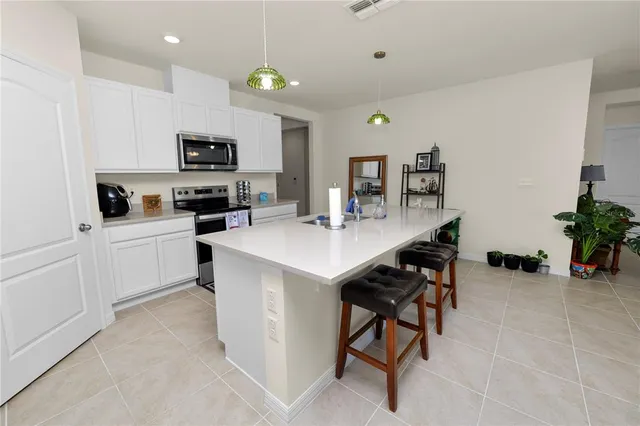 a kitchen with a sink a microwave and cabinets