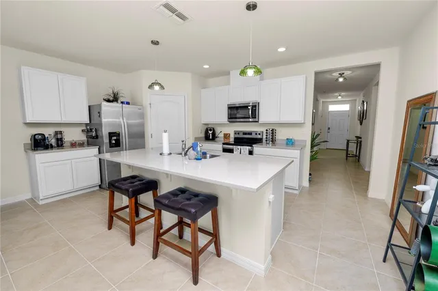 a kitchen with kitchen island a sink a counter and appliances