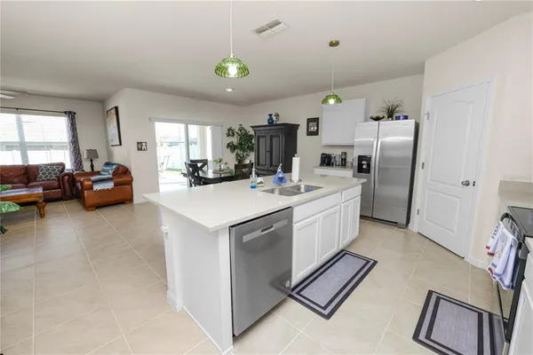 a kitchen that has a lot of cabinets and refrigerator
