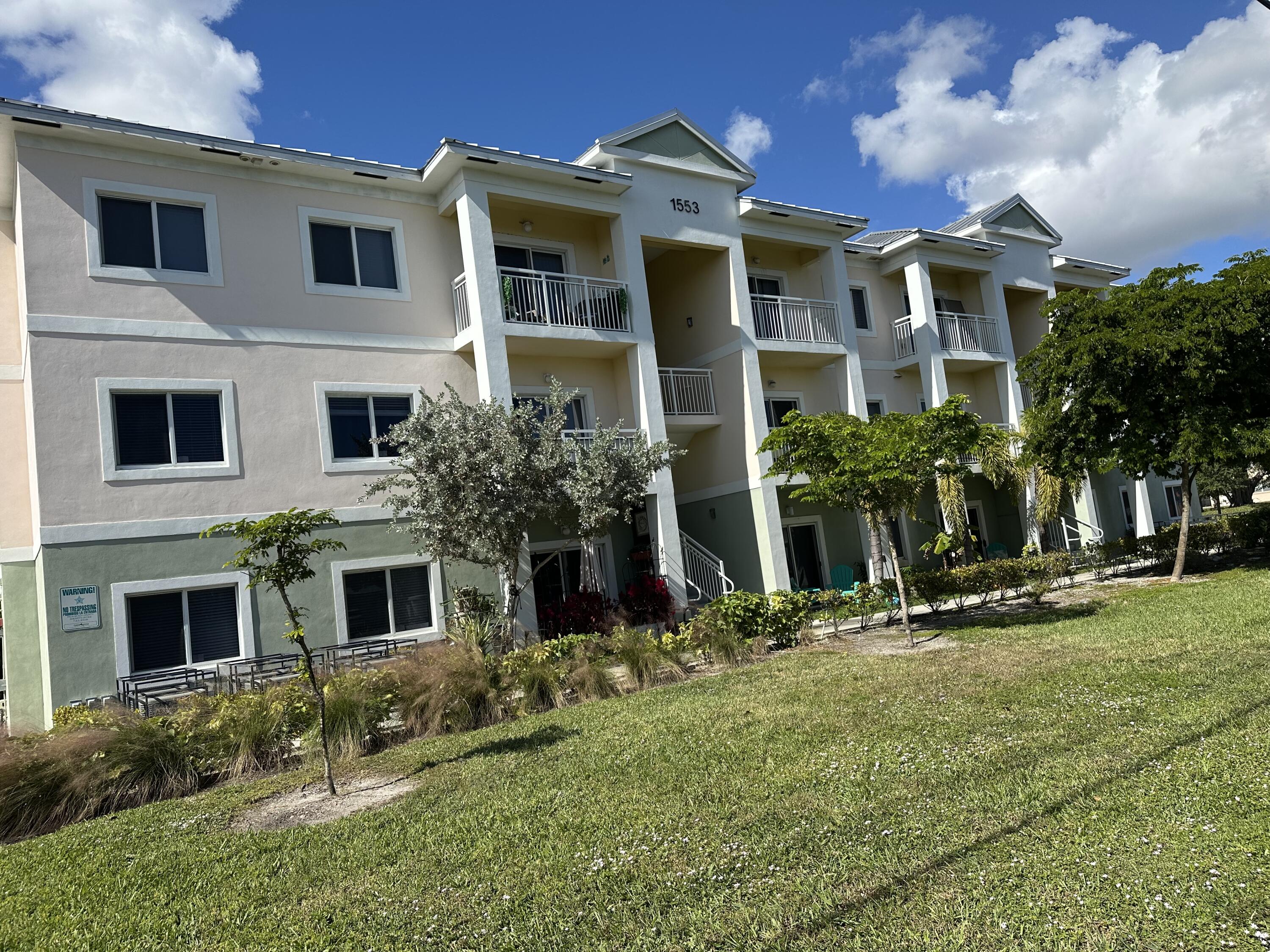 1553 Florida Mango Road, Unit 103 Palm Springs, FL 33406 - Photo 1 of 1 a front view of a house with a yard
