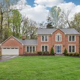 a front view of a house with a garden and yard