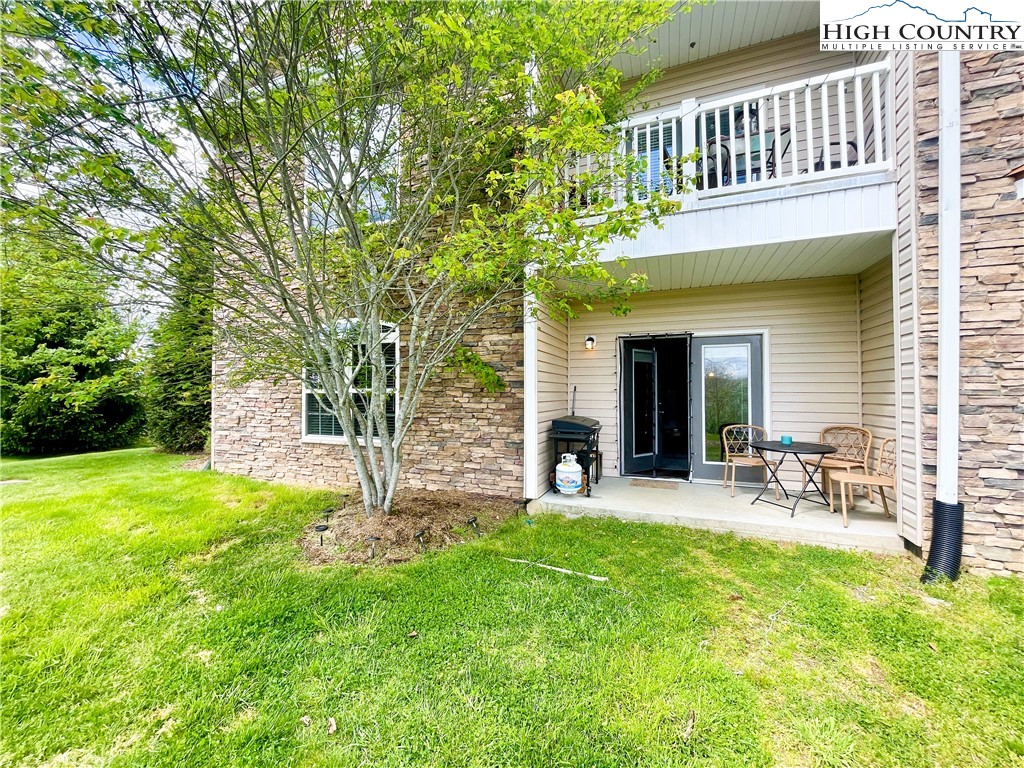 a view of a house with a yard and sitting area