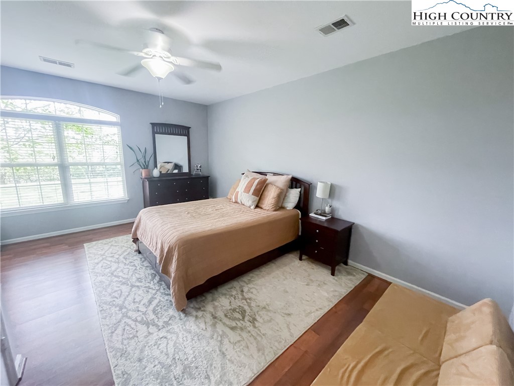 190 Eli Hartley Drive, Unit 112 Boone, NC 28607 - Photo 11 of 20 a bedroom with a bed lamp and a large window