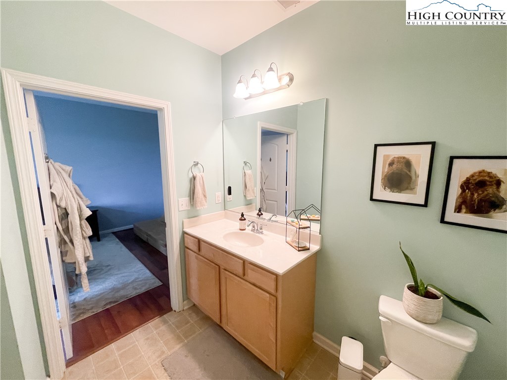 190 Eli Hartley Drive, Unit 112 Boone, NC 28607 - Photo 13 of 20 a bathroom with a toilet sink and mirror