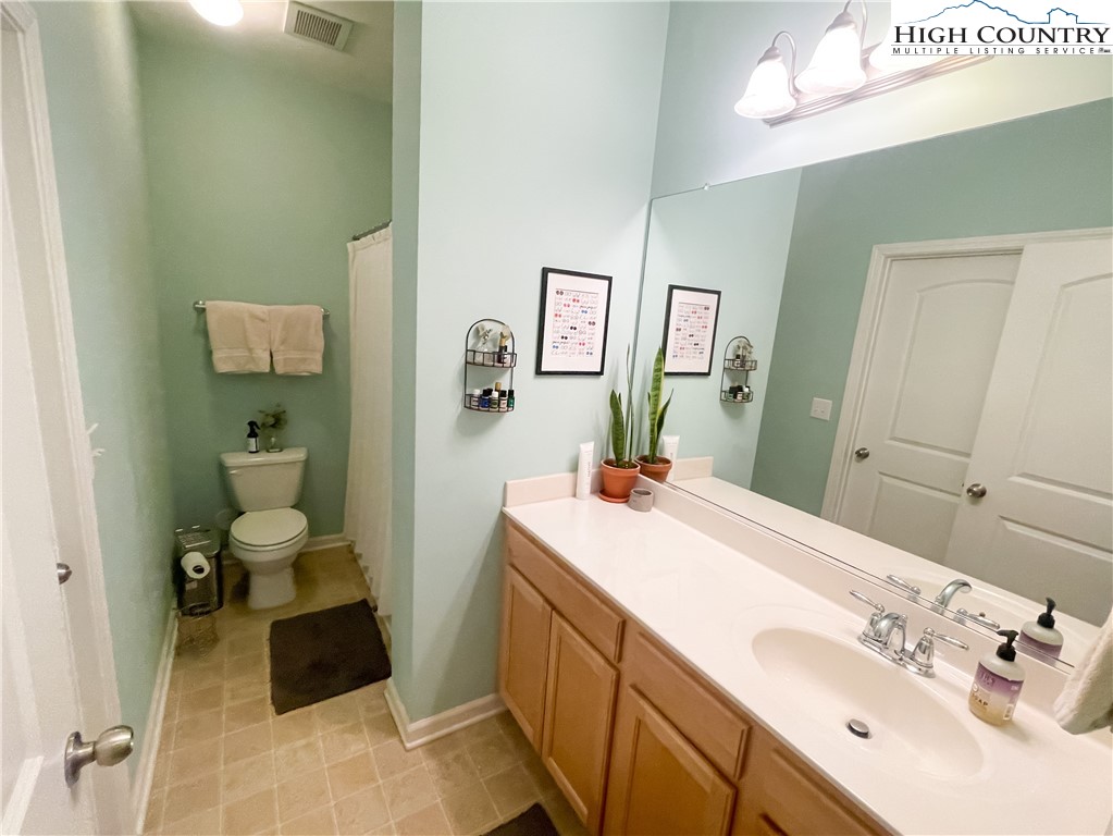 190 Eli Hartley Drive, Unit 112 Boone, NC 28607 - Photo 17 of 20 a spacious bathroom with a sink double vanity and a toilet