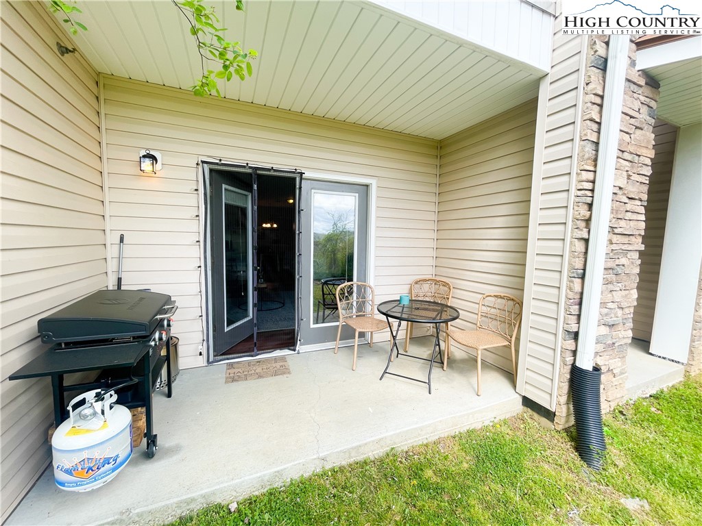 190 Eli Hartley Drive, Unit 112 Boone, NC 28607 - Photo 18 of 20 a view of a patio with chair and tables back yard of the house