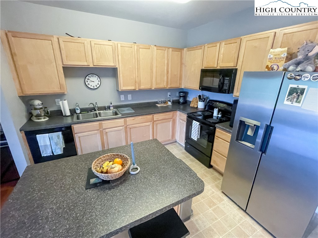 190 Eli Hartley Drive, Unit 112 Boone, NC 28607 - Photo 3 of 20 a kitchen with stainless steel appliances granite countertop a sink a stove counter space and a window
