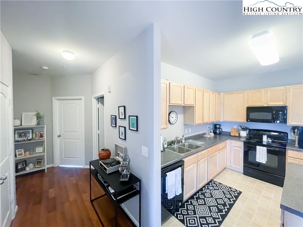 190 Eli Hartley Drive, Unit 112 Boone, NC 28607 - Photo 7 of 20 a kitchen with granite countertop a stove and cabinets