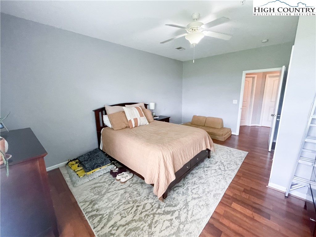 190 Eli Hartley Drive, Unit 112 Boone, NC 28607 - Photo 10 of 20 a bedroom with a bed rug and wooden floor