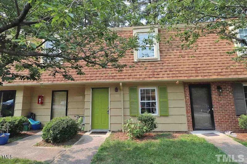 141 Jones Franklin Road, Unit E Raleigh, NC 27606 - Photo 2 of 20 front view of a house with a yard