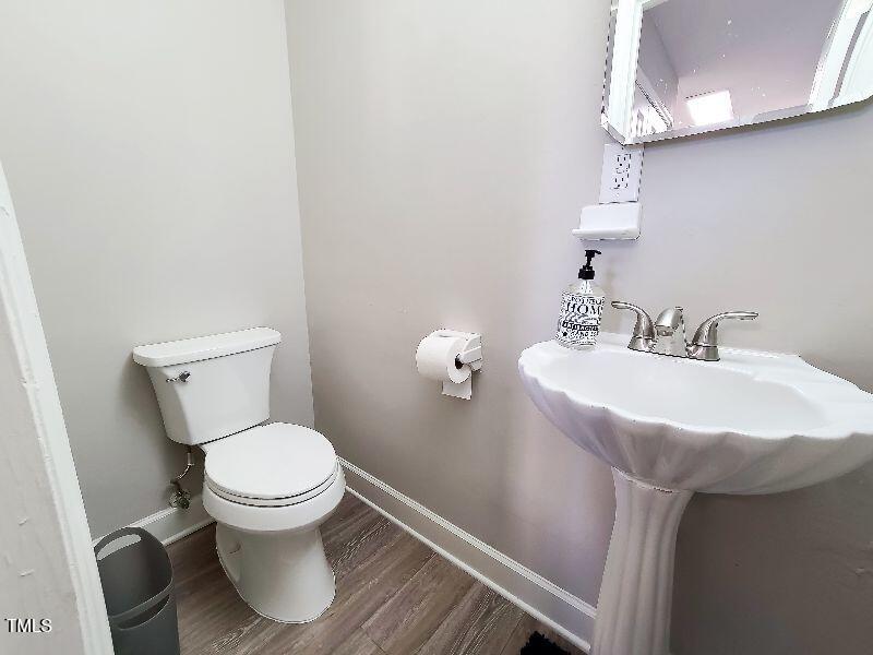 141 Jones Franklin Road, Unit E Raleigh, NC 27606 - Photo 6 of 20 a bathroom with a sink toilet and a mirror