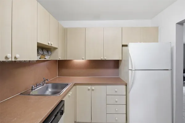 a kitchen with a refrigerator and a sink