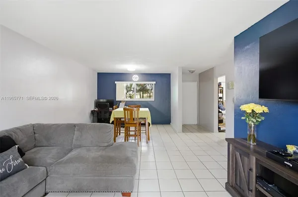 a living room with furniture and a flat screen tv
