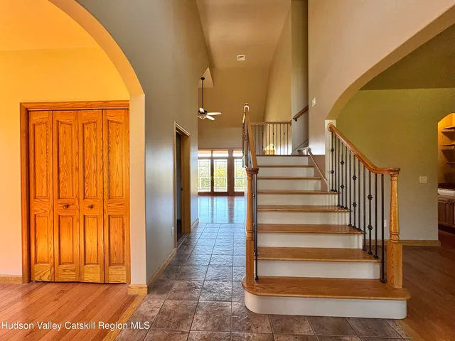 a view of a hallway with wooden floor and a potted plant