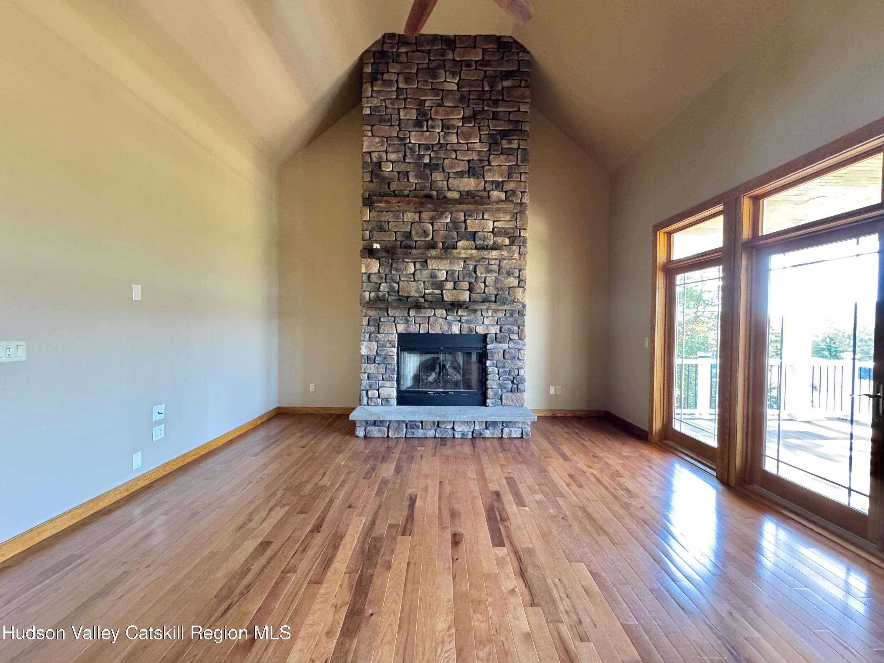3071 Old Kings Road Catskill, NY 12414 - Photo 18 of 53 wooden floor fireplace and windows in an empty room