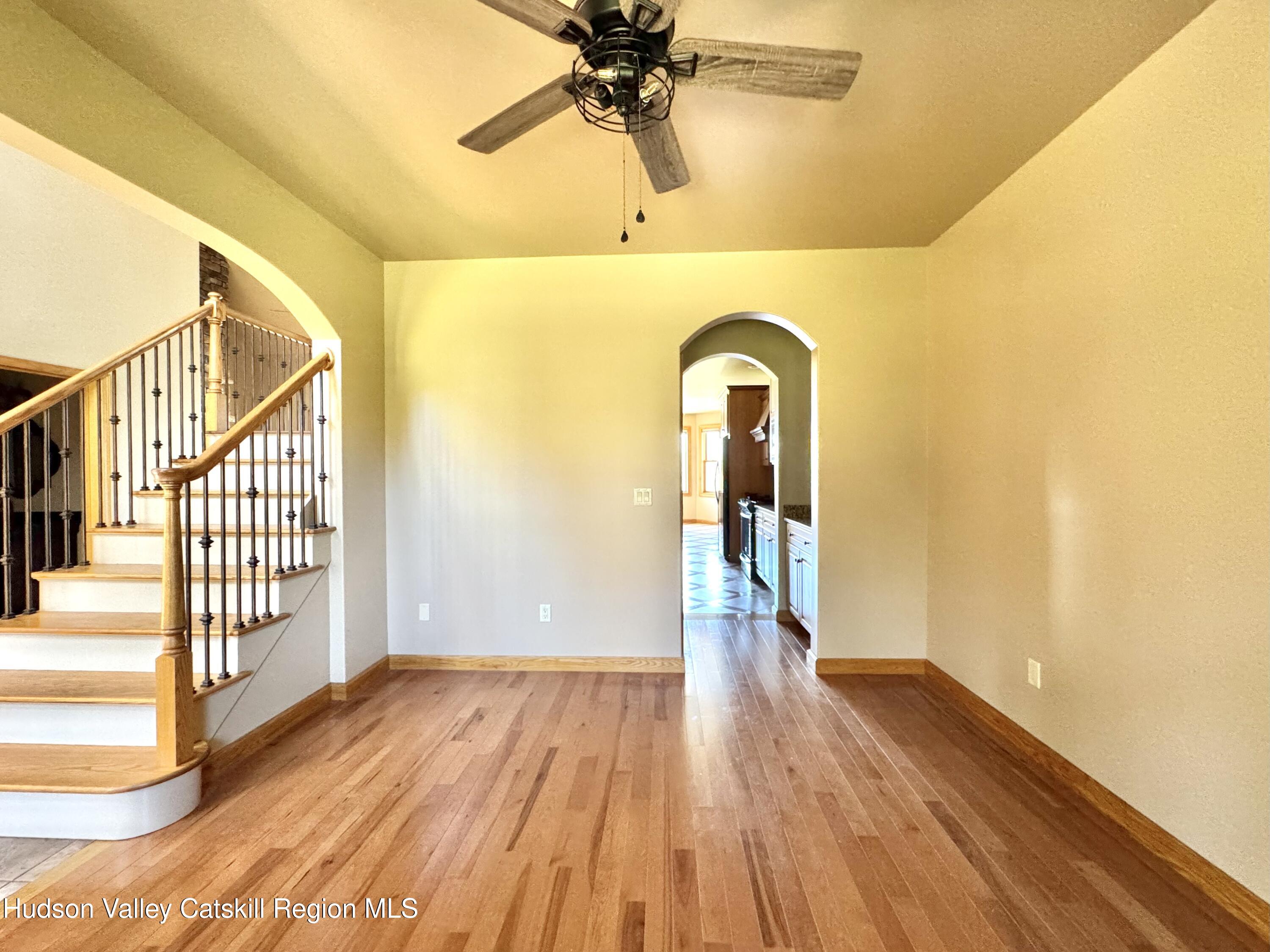 3071 Old Kings Road Catskill, NY 12414 - Photo 22 of 53 a view of a room with wooden floor a ceiling fan and windows