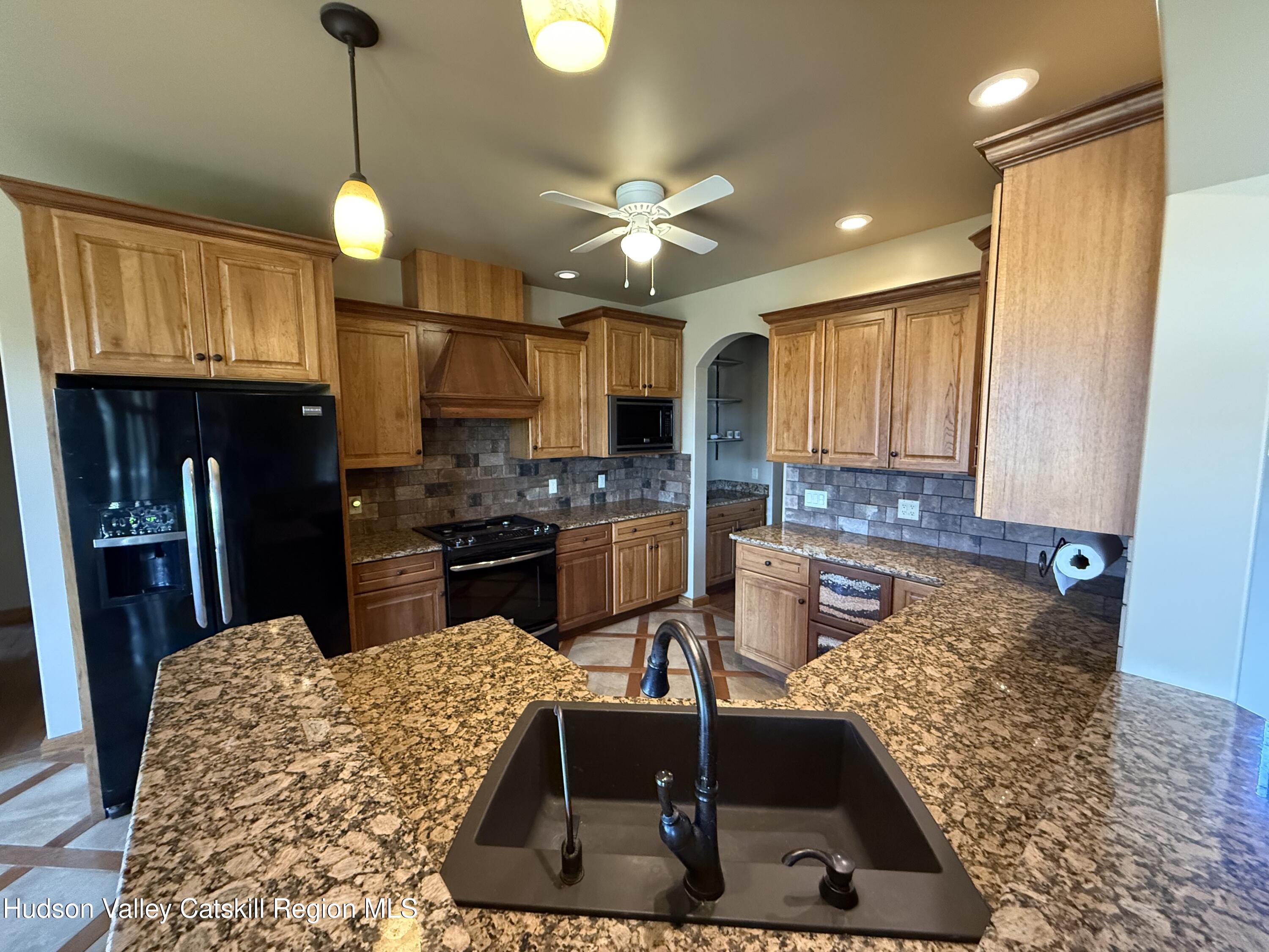 3071 Old Kings Road Catskill, NY 12414 - Photo 25 of 53 a kitchen with stainless steel appliances granite countertop a sink a stove and a refrigerator