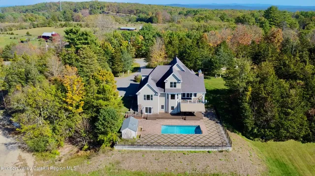 a view of a house with a small yard plants and large tree
