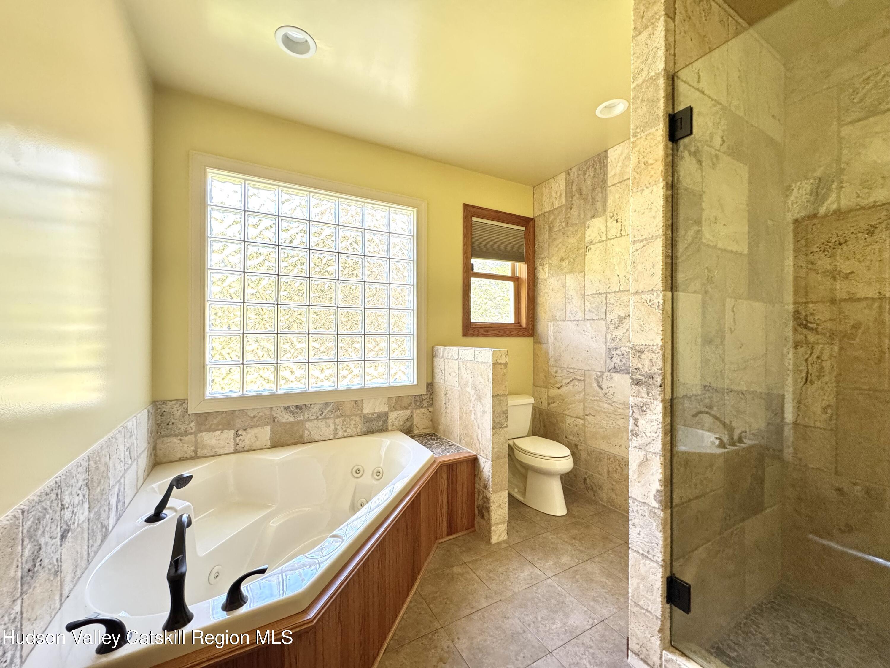 3071 Old Kings Road Catskill, NY 12414 - Photo 32 of 53 a bathroom with a granite countertop tub toilet a sink and a shower