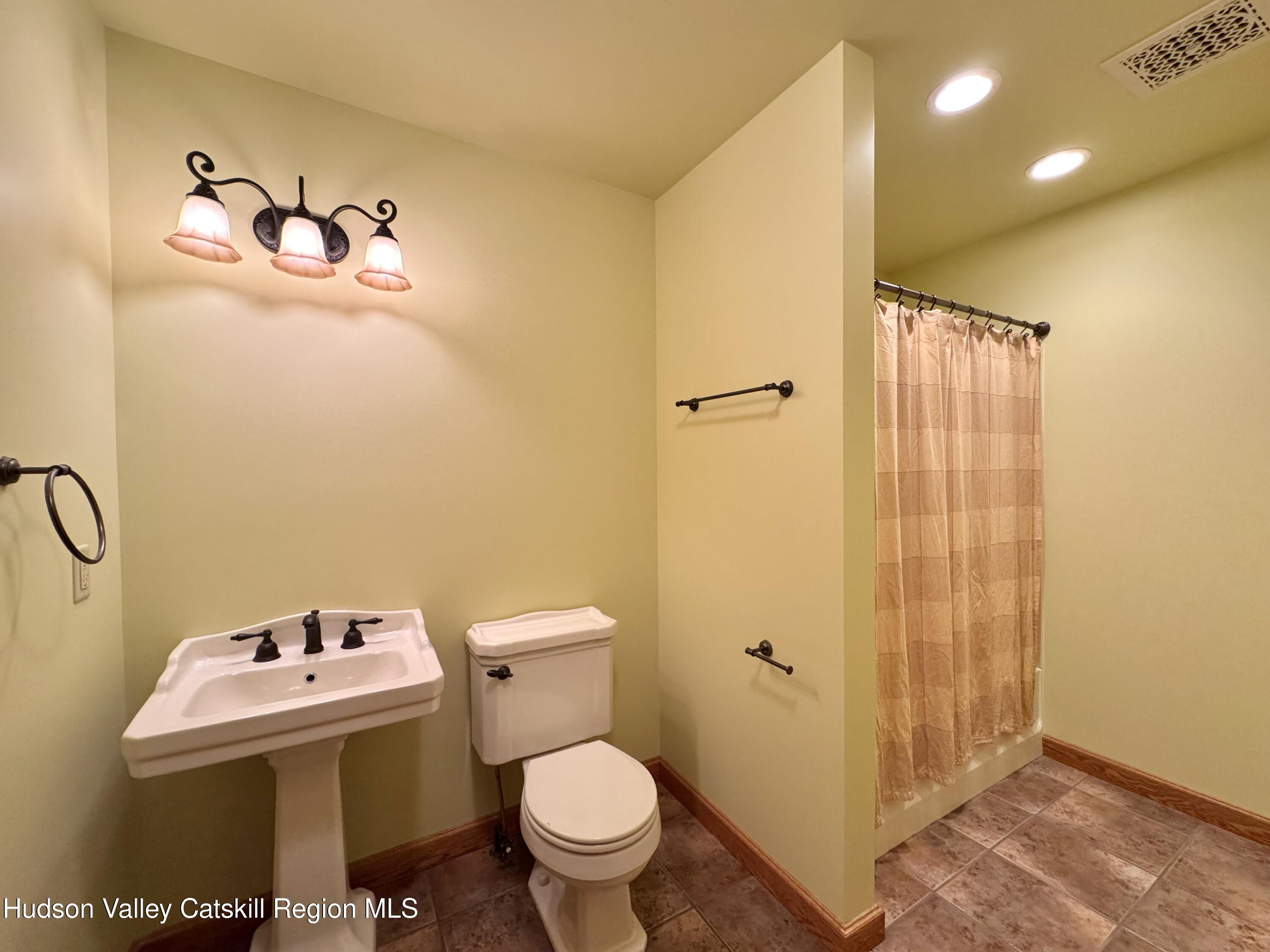 3071 Old Kings Road Catskill, NY 12414 - Photo 36 of 53 a bathroom with a sink mirror and toilet
