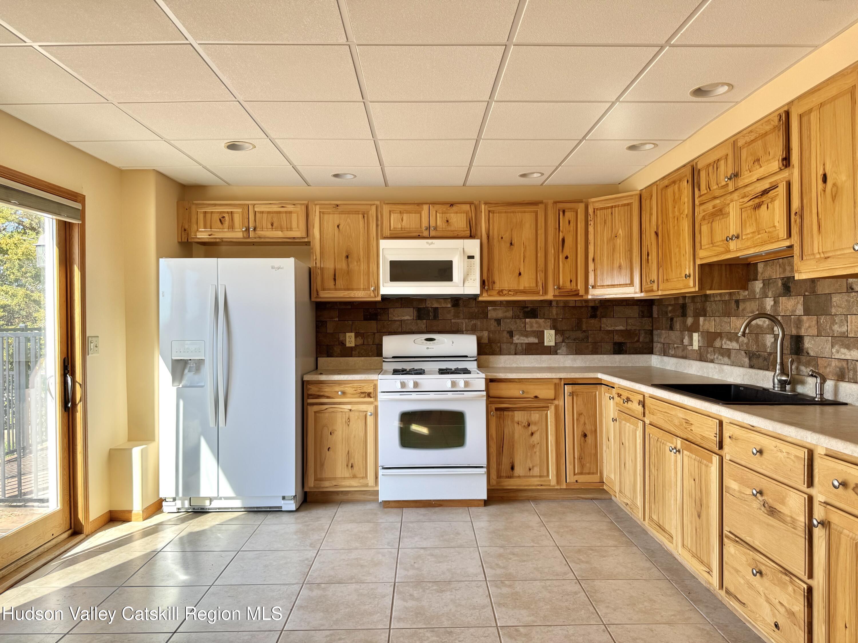 3071 Old Kings Road Catskill, NY 12414 - Photo 42 of 53 a kitchen with stainless steel appliances granite countertop a stove a sink dishwasher and a refrigerator