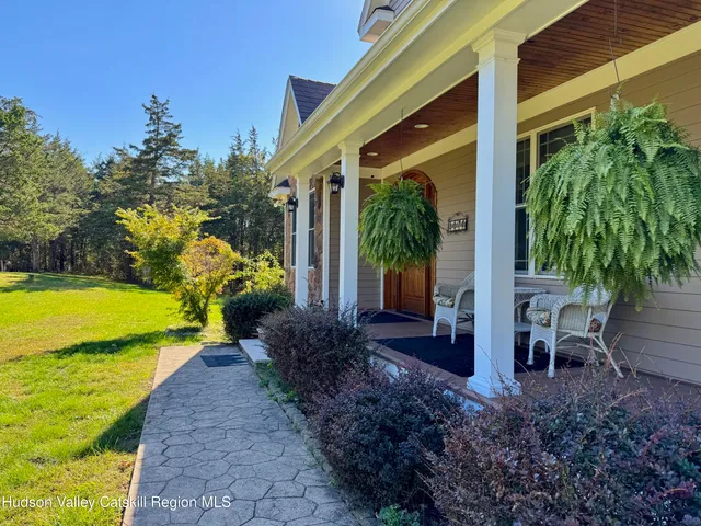 a view of a patio with table and chairs potted plants and palm tree