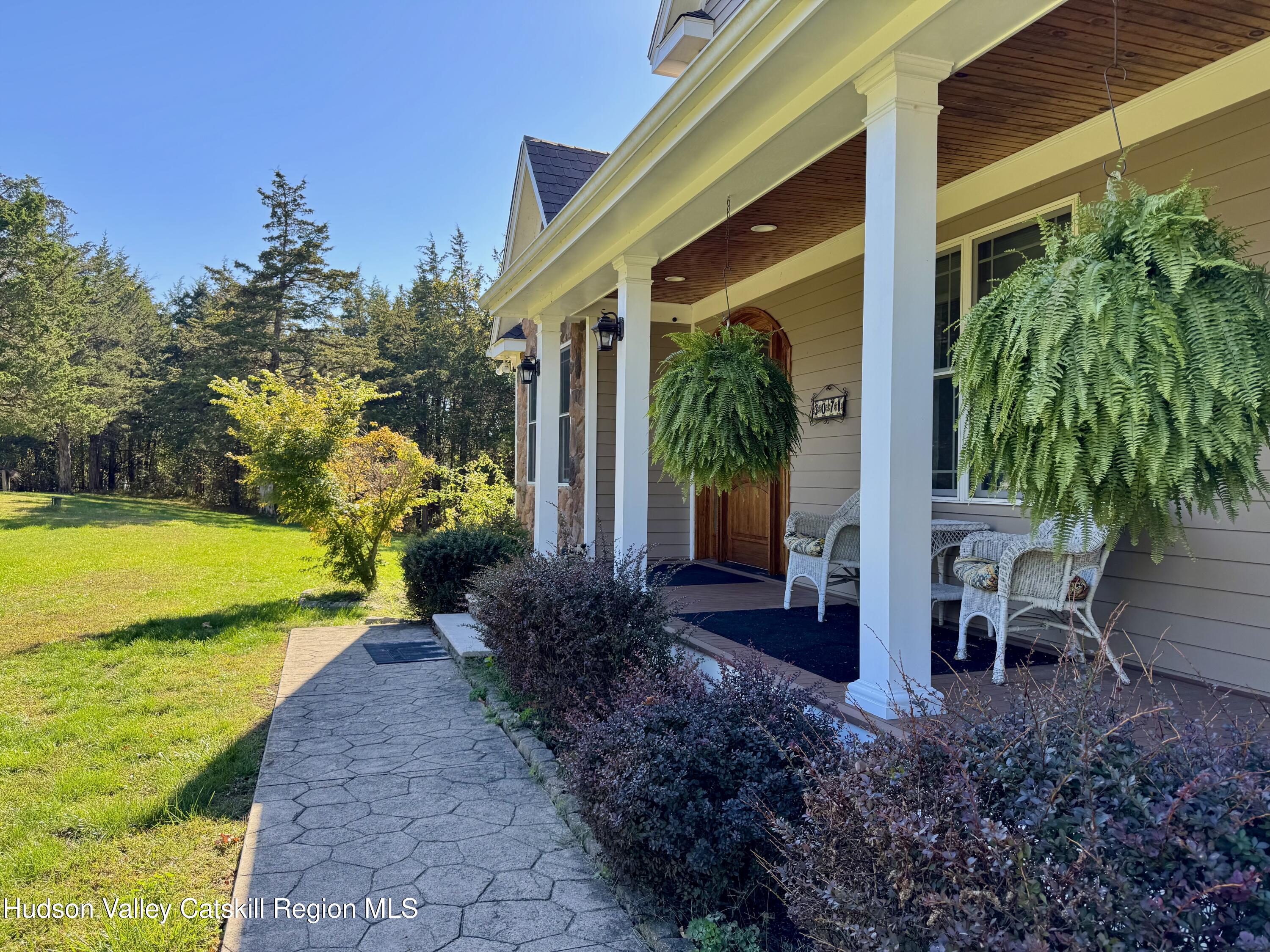 3071 Old Kings Road Catskill, NY 12414 - Photo 7 of 53 a view of a patio with table and chairs potted plants and palm tree