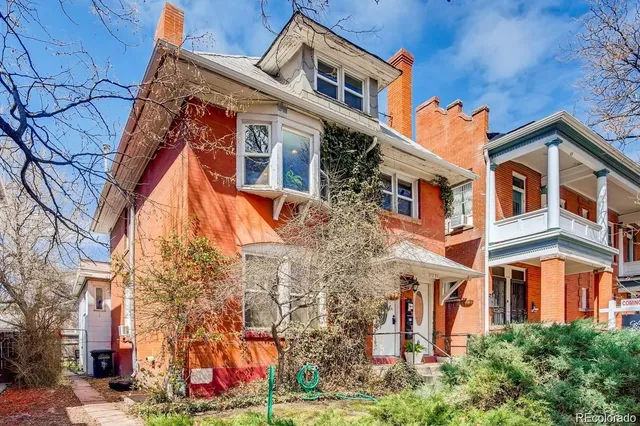 a front view of a residential apartment building with yard