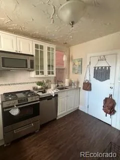 a kitchen with stainless steel appliances granite countertop a stove and a sink
