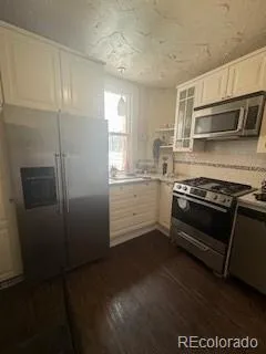 a kitchen with a stove and a refrigerator