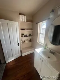 a kitchen with white cabinets and sink