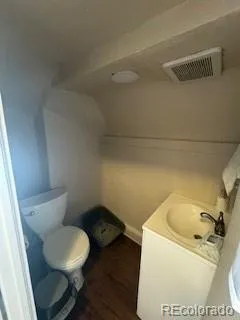 a white toilet sitting next to a bathroom sink
