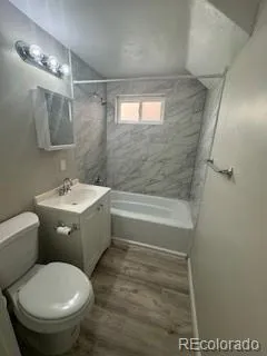 a bathroom with a toilet a sink and bathtub