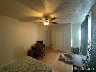 a room with a bed and a ceiling fan