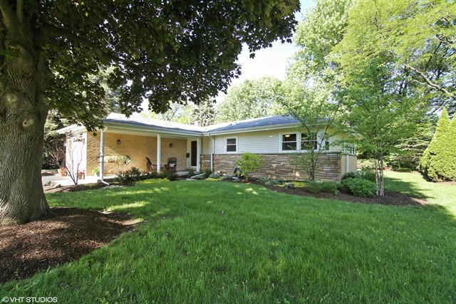 1528 Sunset Ridge Road Glenview, IL 60025 - Photo 1 of 11 a front view of a house with a yard and porch