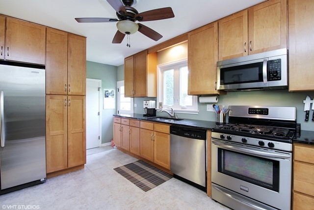 1528 Sunset Ridge Road Glenview, IL 60025 - Photo 3 of 11 a kitchen with stainless steel appliances granite countertop a stove a refrigerator and a microwave