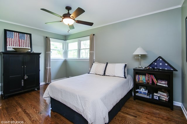 1528 Sunset Ridge Road Glenview, IL 60025 - Photo 7 of 11 a bedroom with a bed and a chandelier