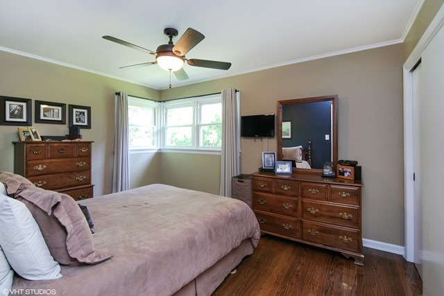 1528 Sunset Ridge Road Glenview, IL 60025 - Photo 8 of 11 a bedroom with a bed and a flat tv screen on dresser