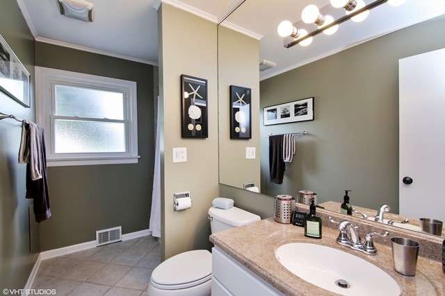 1528 Sunset Ridge Road Glenview, IL 60025 - Photo 9 of 11 a bathroom with a sink a toilet and mirror