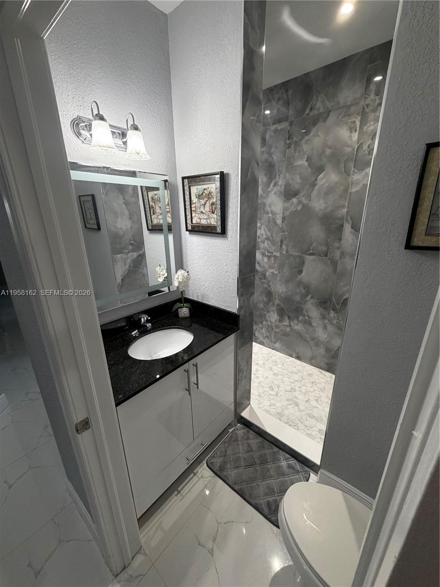 3281 Southwest 145th Avenue Miami, FL 33175 - Photo 20 of 56 a bathroom with a sink a toilet and shower