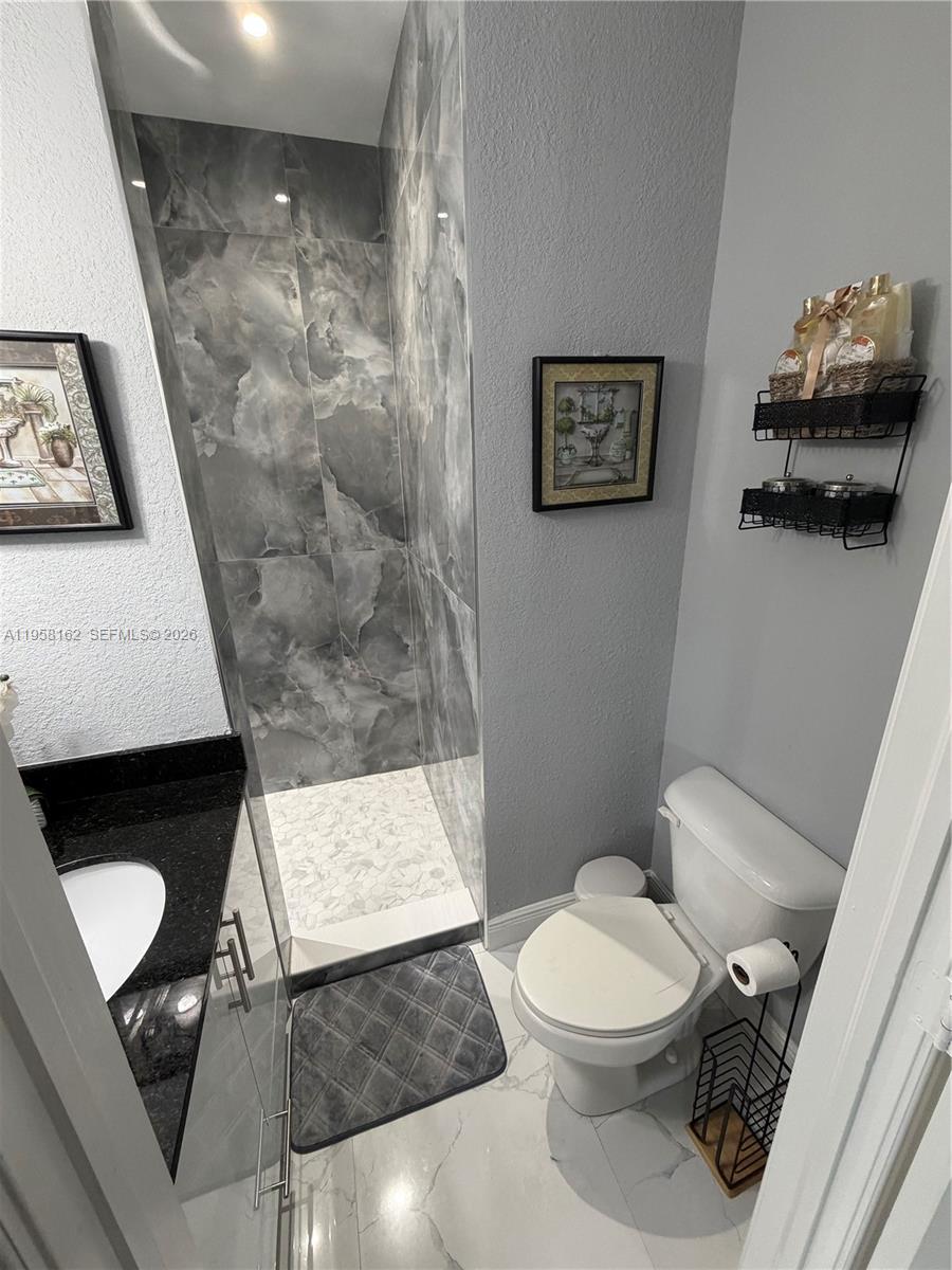3281 Southwest 145th Avenue Miami, FL 33175 - Photo 22 of 56 a bathroom with a toilet and a shower