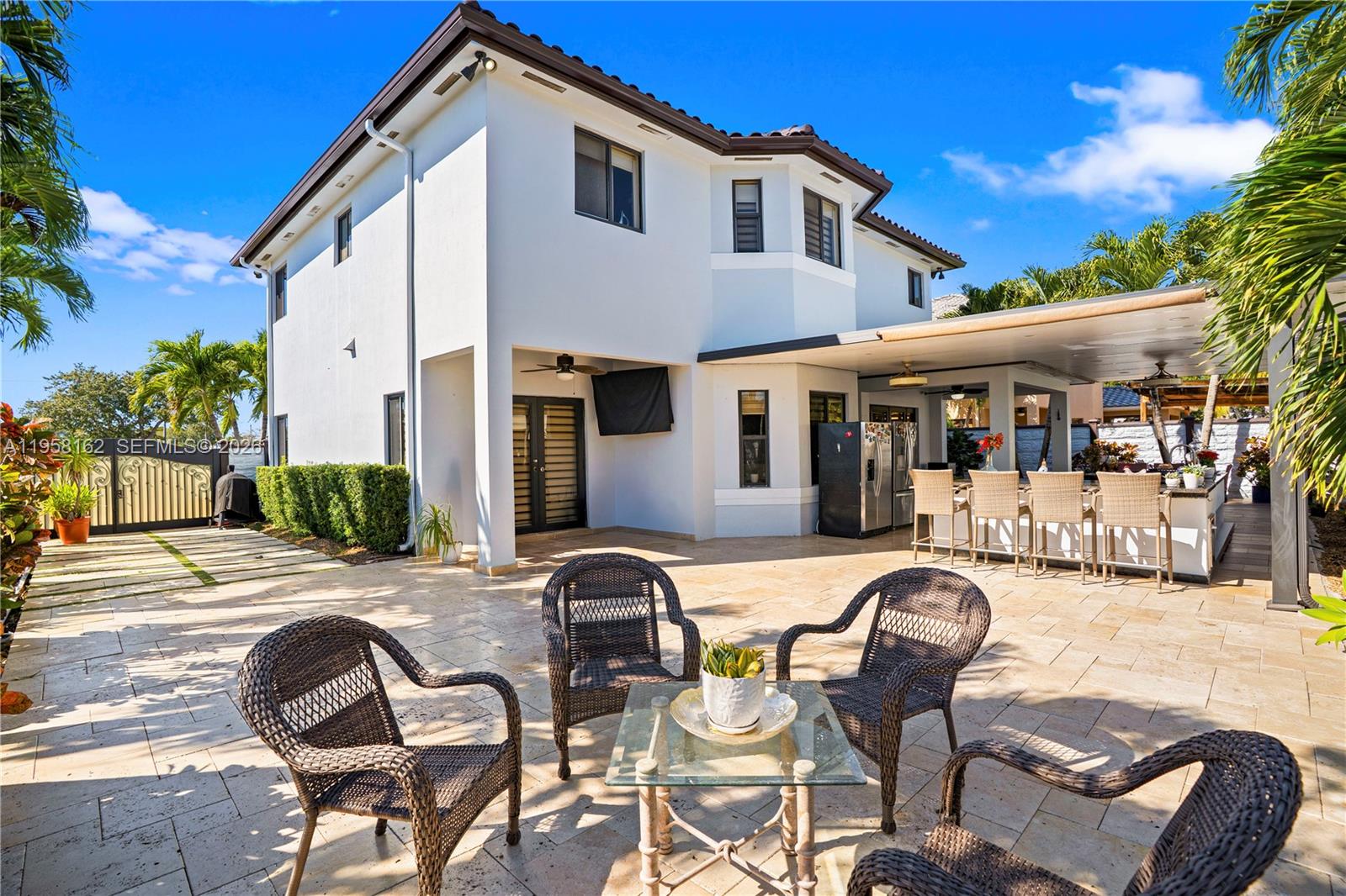 3281 Southwest 145th Avenue Miami, FL 33175 - Photo 27 of 56 a front view of a house with patio furniture and fire pit