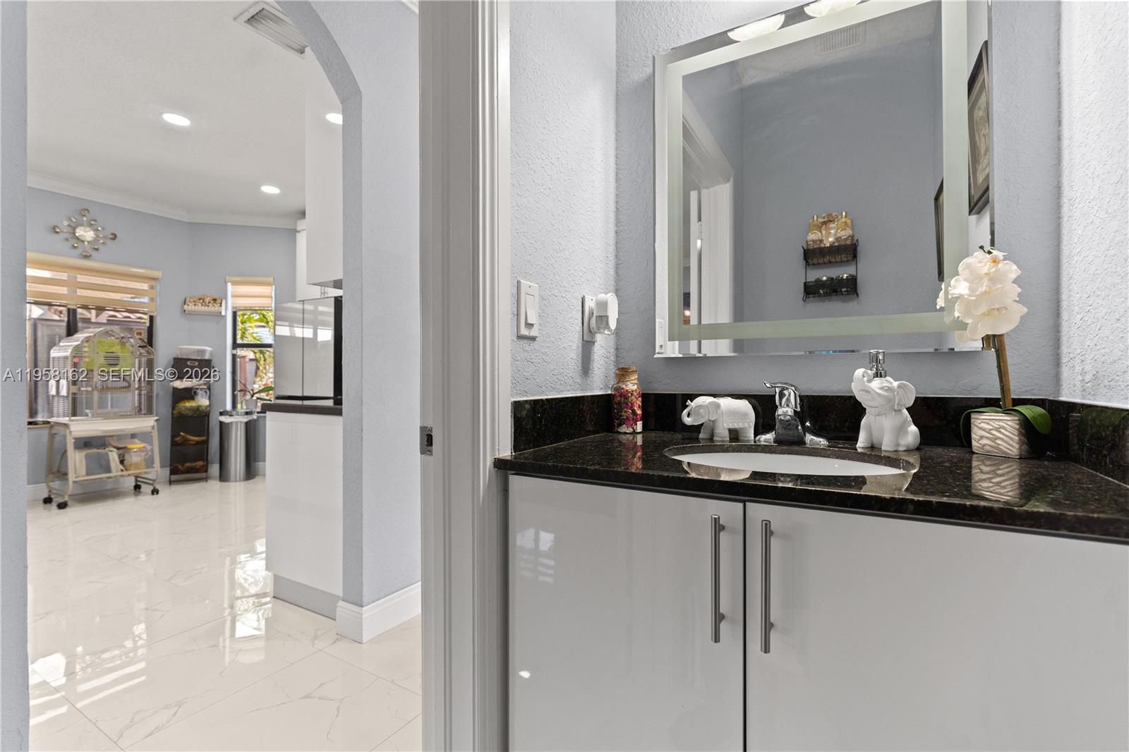 3281 Southwest 145th Avenue Miami, FL 33175 - Photo 33 of 56 a bathroom with a sink and a mirror