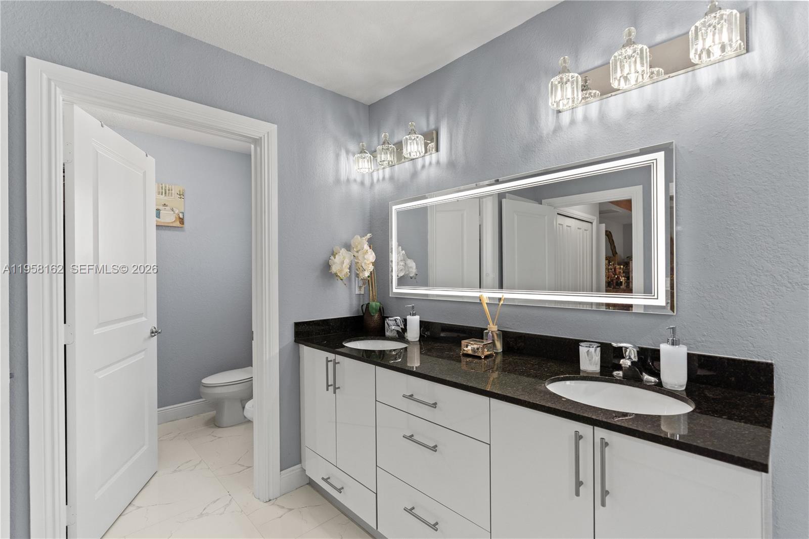 3281 Southwest 145th Avenue Miami, FL 33175 - Photo 43 of 56 a bathroom with a granite countertop sink and a mirror